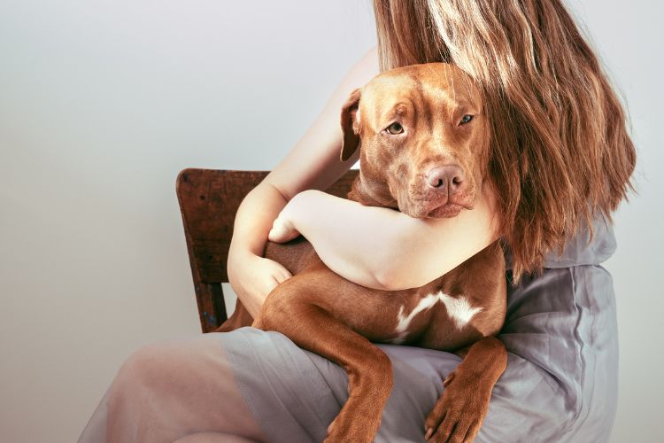 woman hugging her dog